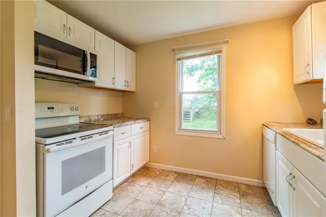a kitchen with a stove microwave and sink
