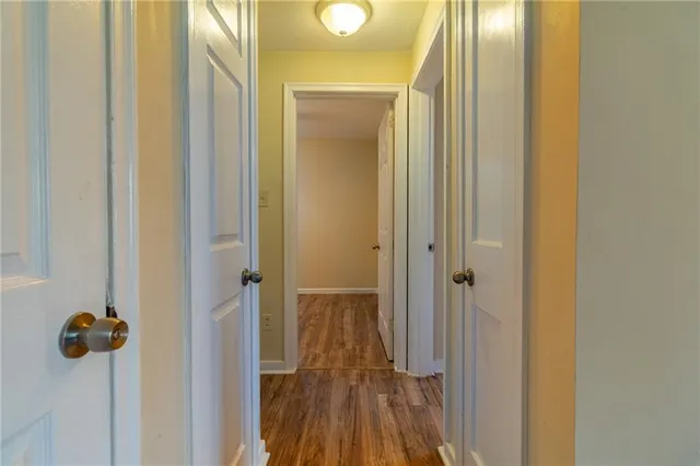 a view of a hallway with wooden floor