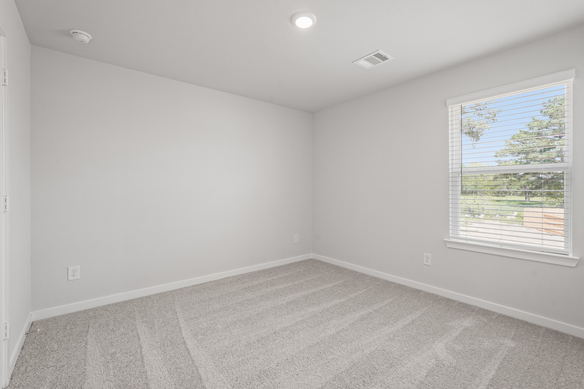 217 Spring Drive Hockley, TX 77447 - Photo 17 of 27 an empty room with a window