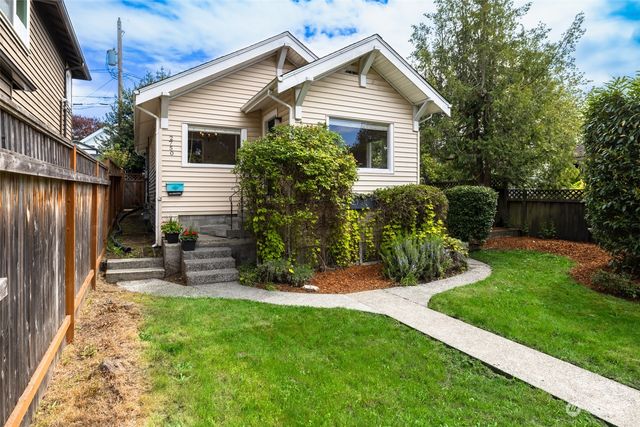 a view of a house with a yard and sitting area