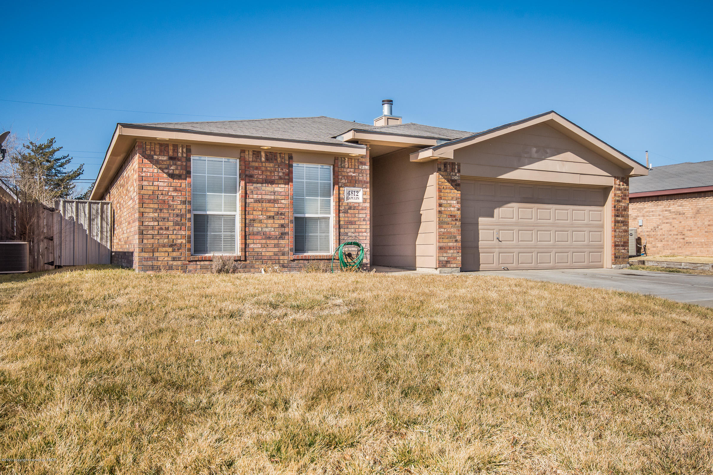 4812 Capulin Lane Amarillo, TX 79110 - Photo 20 of 20 a front view of a house with a yard