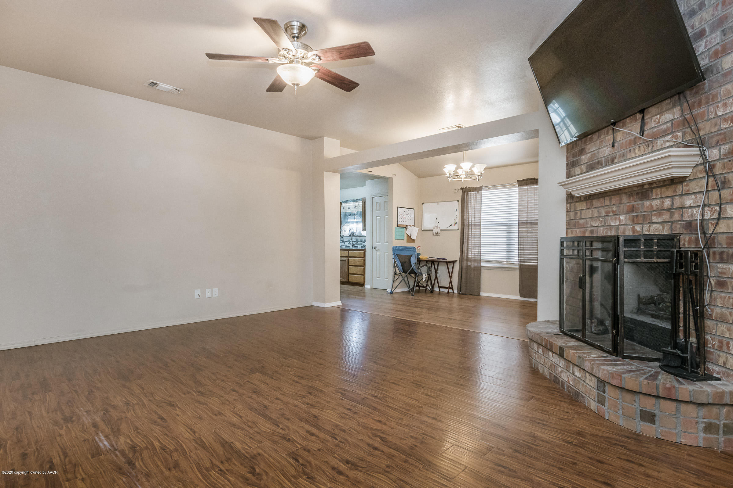 4812 Capulin Lane Amarillo, TX 79110 - Photo 2 of 20 a view of empty room with wooden floor and fireplace