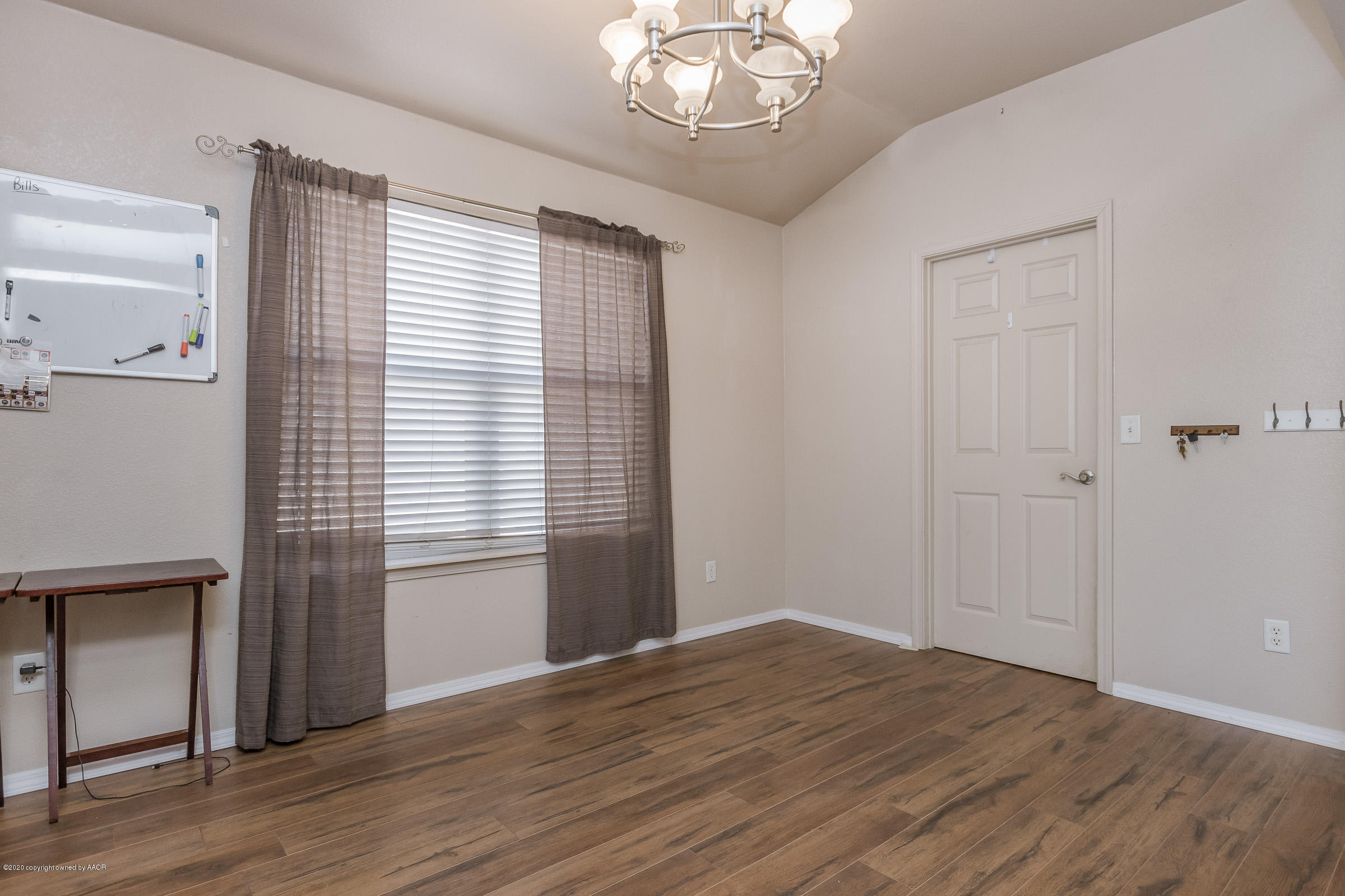 4812 Capulin Lane Amarillo, TX 79110 - Photo 4 of 20 wooden floor in an empty room with a window