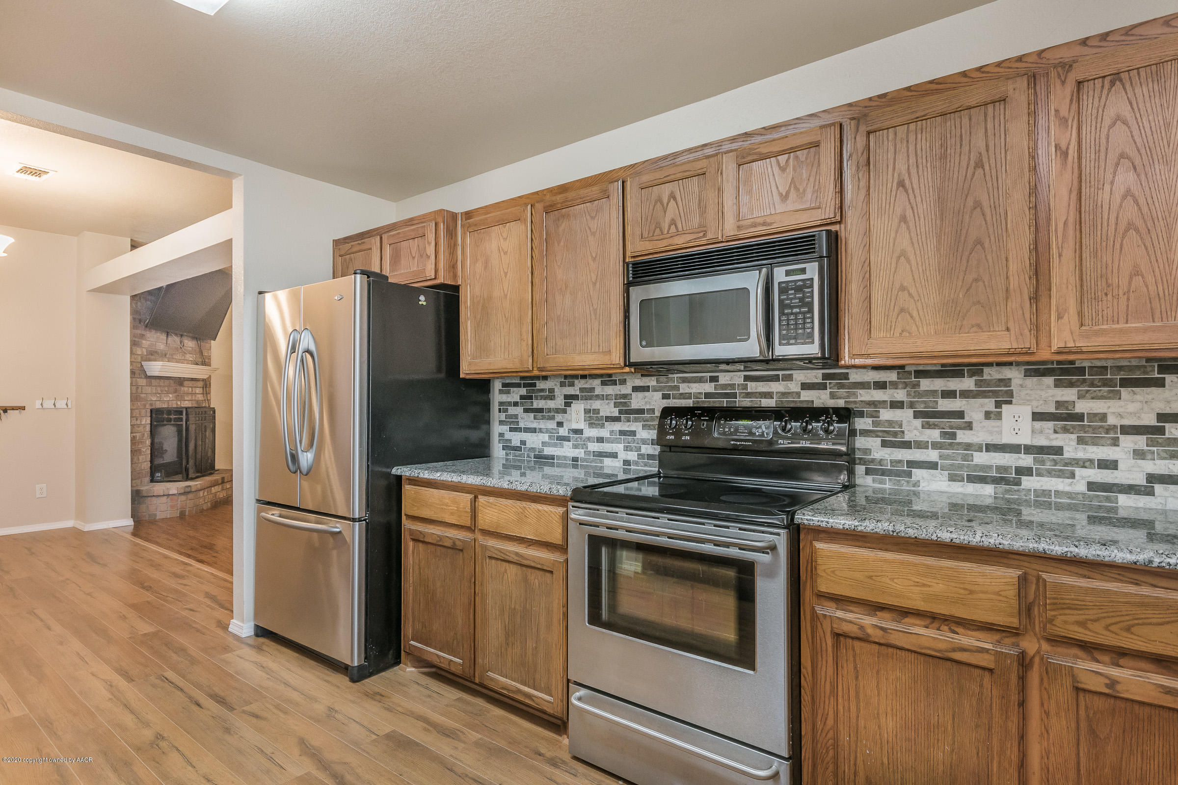 4812 Capulin Lane Amarillo, TX 79110 - Photo 6 of 20 a kitchen with granite countertop wooden cabinets stainless steel appliances and a granite counter tops
