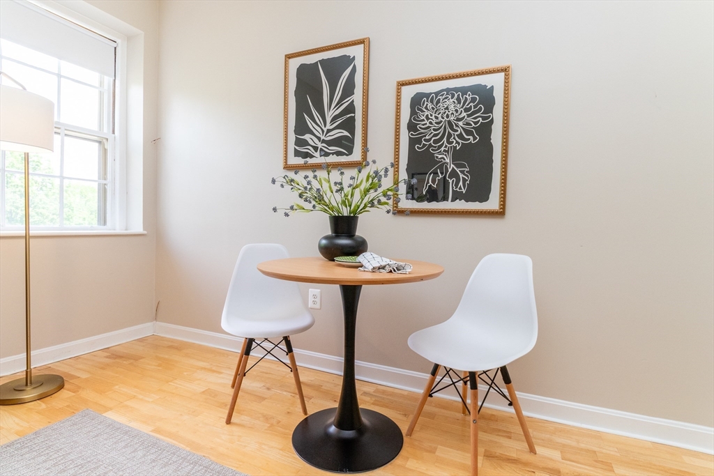 60e Glen Road, Unit 306 Brookline, MA 02445 - Photo 8 of 27 a view of a room with a table and chair