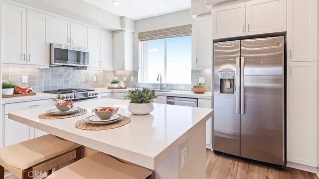 a kitchen with refrigerator and cabinets