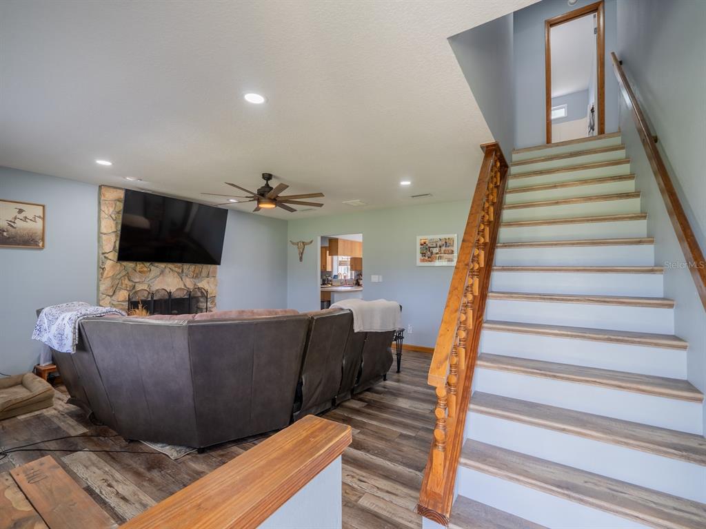 4381 Northeast 105th Place Anthony, FL 32617 - Photo 28 of 49 a living room with furniture and a flat screen tv