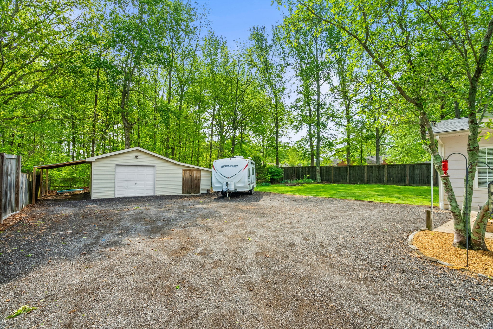 4120 Sycamore Road Greenbrier, TN 37073 - Photo 25 of 31 a white house with a big yard and large trees