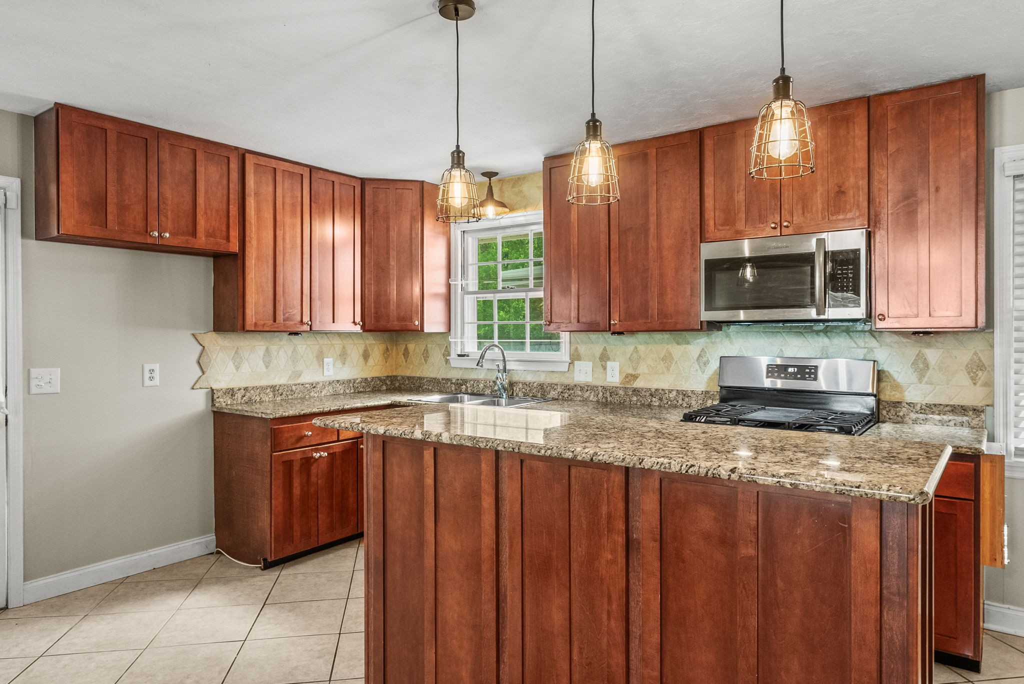 4120 Sycamore Road Greenbrier, TN 37073 - Photo 9 of 31 a kitchen with stainless steel appliances granite countertop wooden cabinets a sink and a window