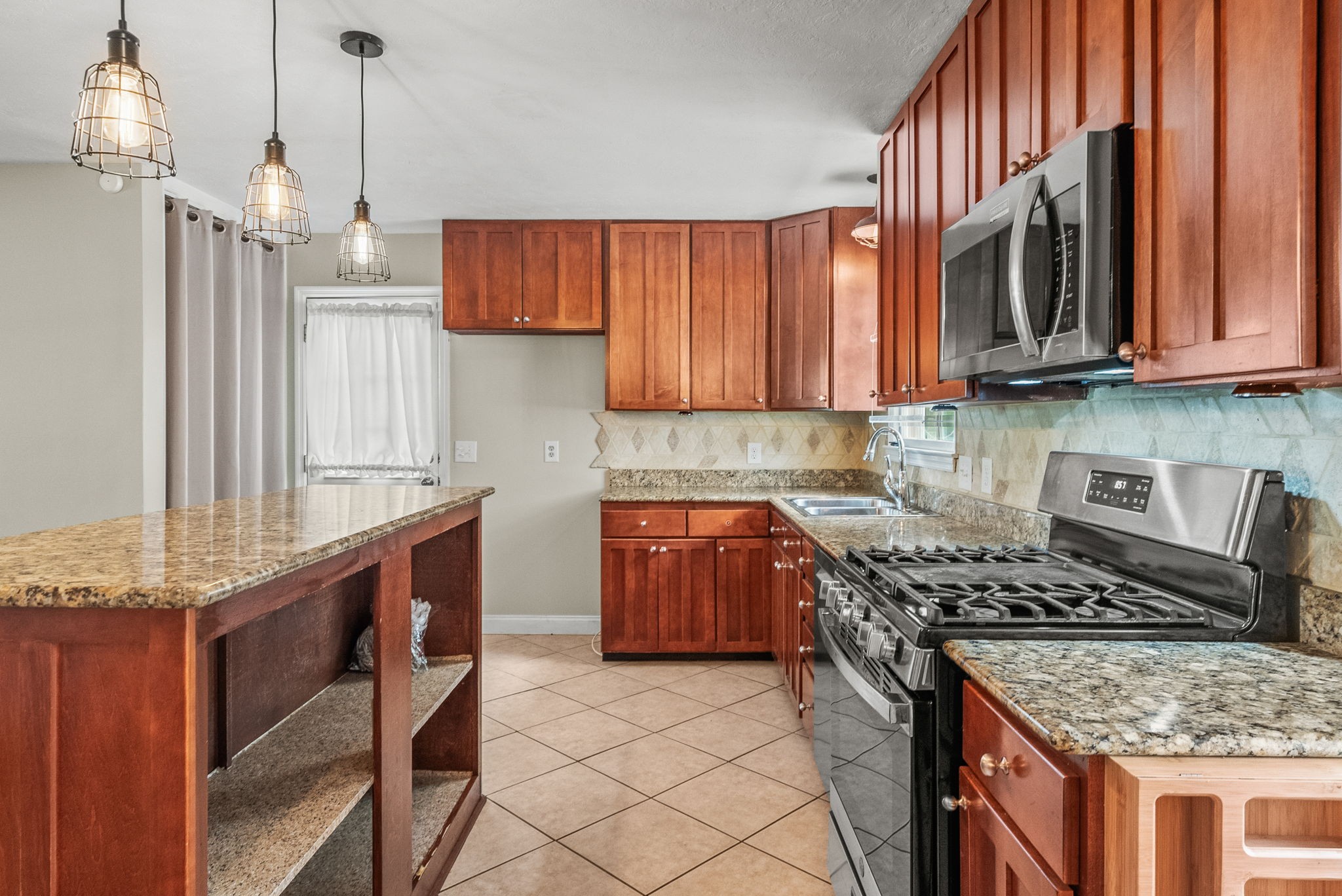 4120 Sycamore Road Greenbrier, TN 37073 - Photo 10 of 31 a kitchen with stainless steel appliances granite countertop a stove a sink dishwasher and a wooden cabinets