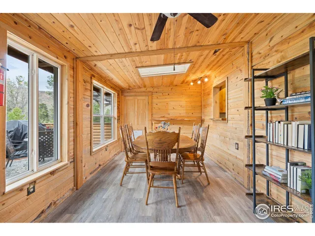 a view of a dining room with furniture and a window