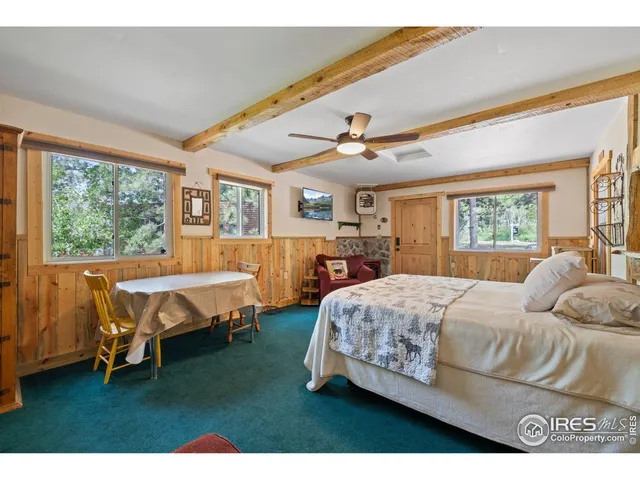 a bedroom with a bed a table and chair