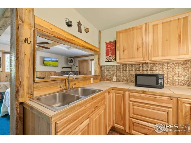 a kitchen with stainless steel appliances granite countertop a sink and a microwave