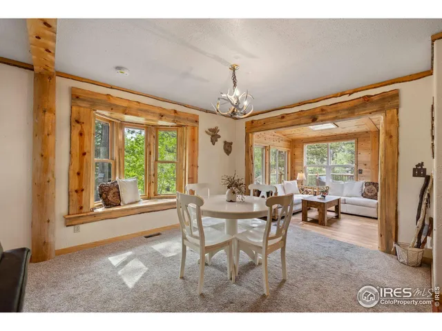 a view of a dining room with furniture large windows and wooden floor