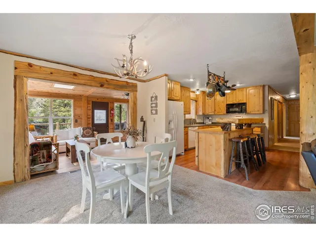 a dining room with furniture a chandelier and wooden floor