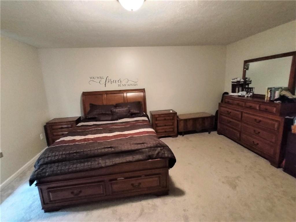 179 South Benbrook Road Butler, PA 16001 - Photo 8 of 21 a bedroom with a bed and a mirror