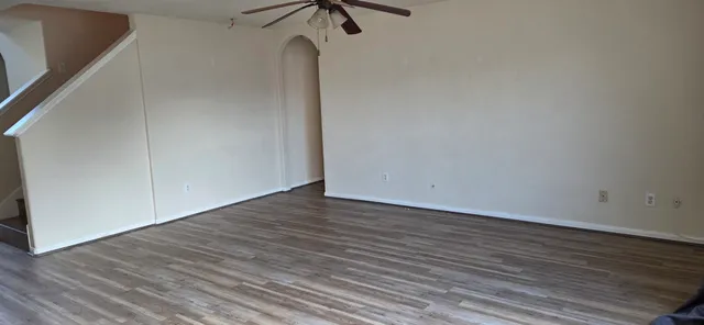 a view of a room with wooden floor