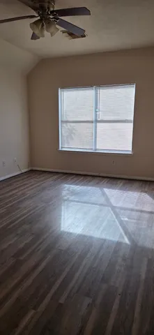 a view of a room with wooden floor and window