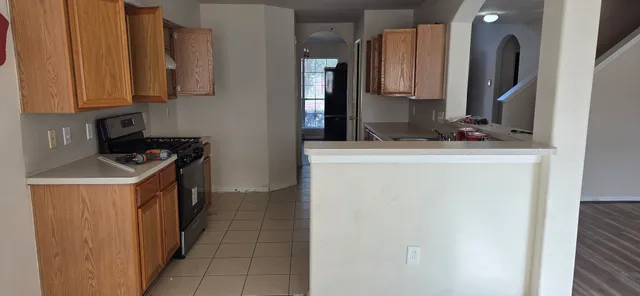 a kitchen with a sink and a stove top oven