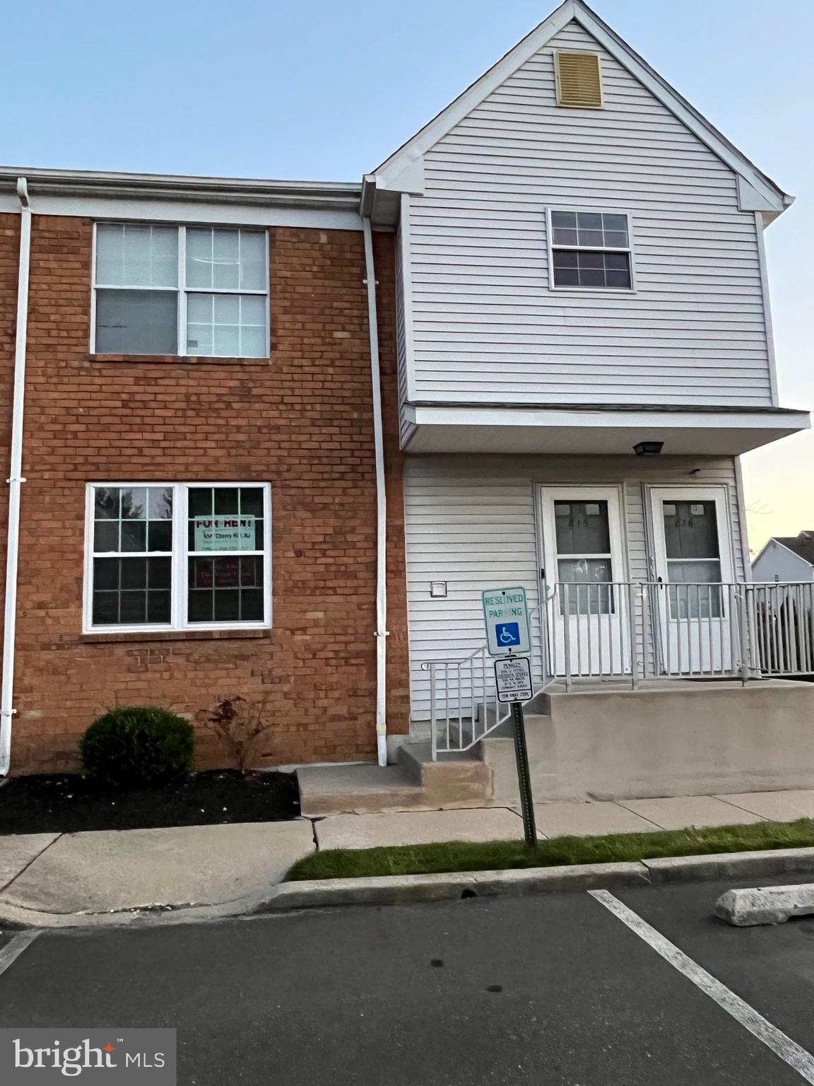 a front view of a house with a road