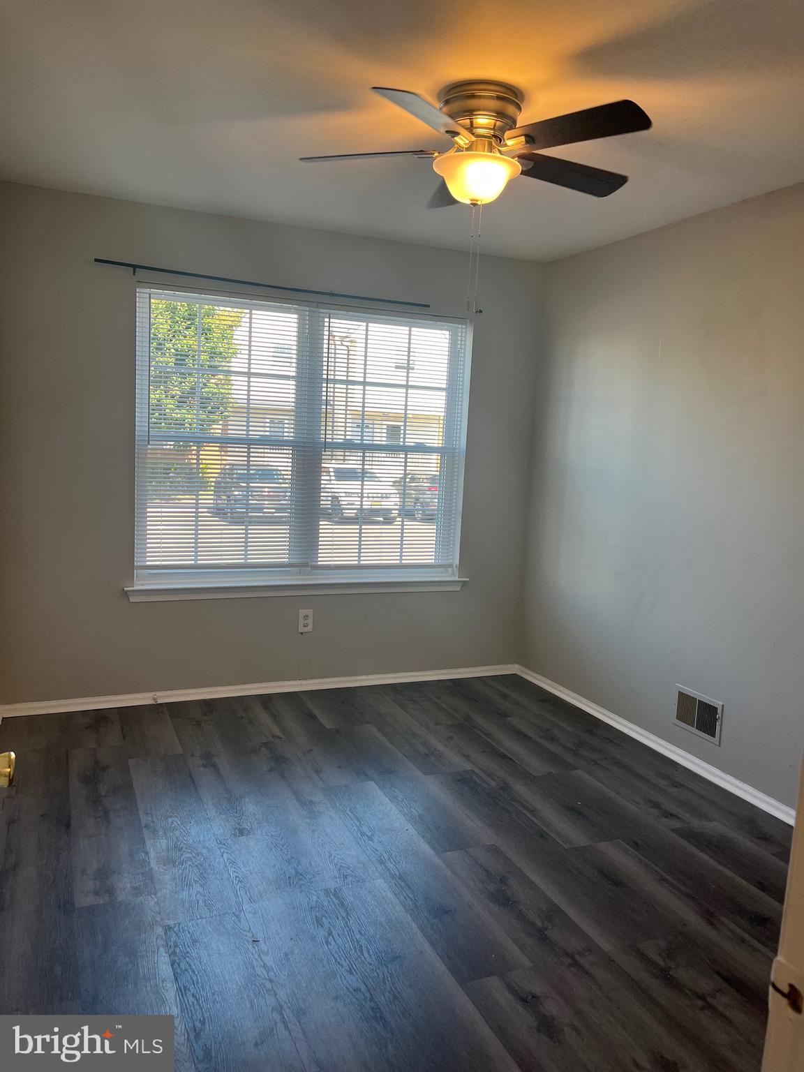 815 Woodchip Road Lumberton, NJ 08048 - Photo 7 of 32 a view of an empty room with wooden floor and a window