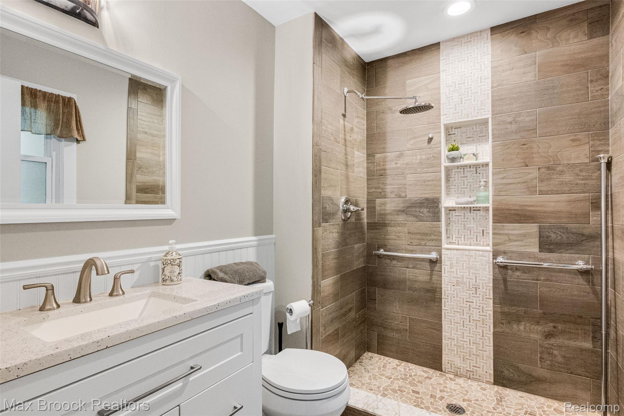 2905 Lahser Road Bloomfield Hills, MI 48304 - Photo 25 of 28 Shower with wood-finish tile, pebble-style floor, and integrated shelving