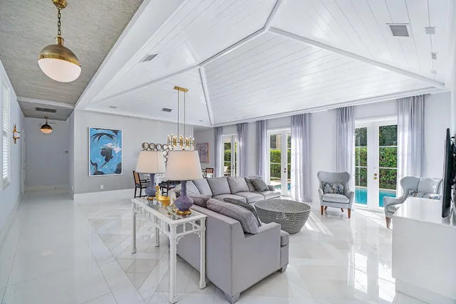 a living room with furniture a rug and a chandelier