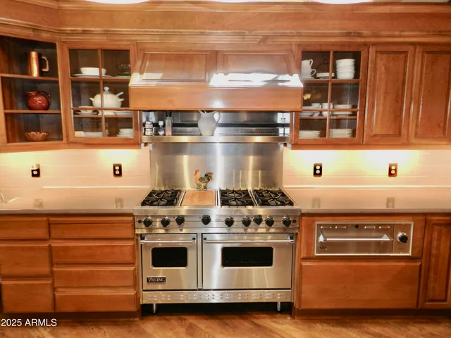 a view of a dining room with furniture a chandelier and wooden floor
