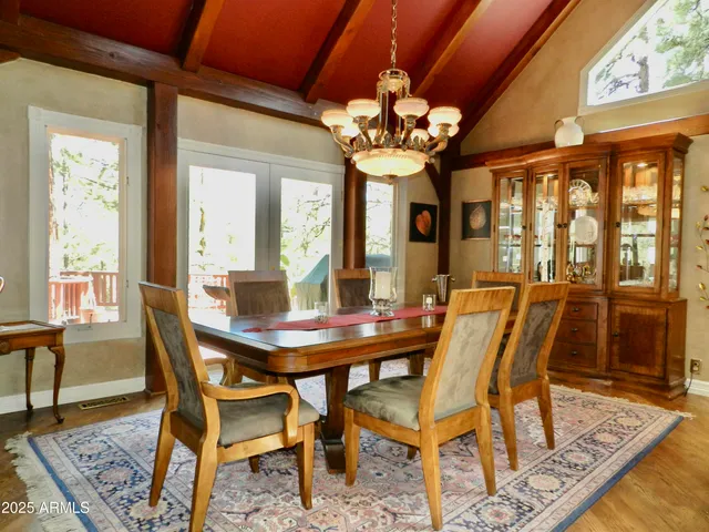 a view of a hallway with wooden floor and a living room