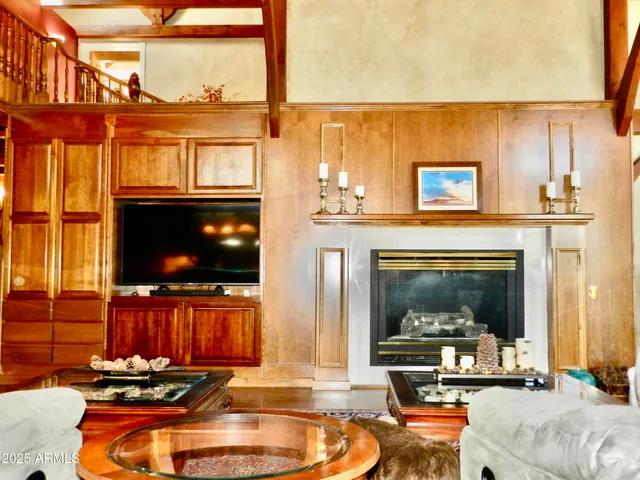 a blue swimming pool with a couch and wooden floor