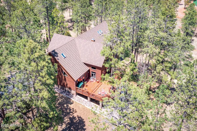 an aerial view of a house with a yard and wooden fence