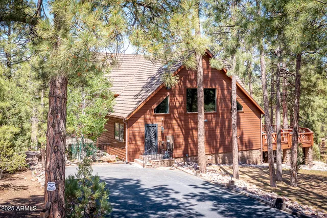 a view of a house with a tree next to a road