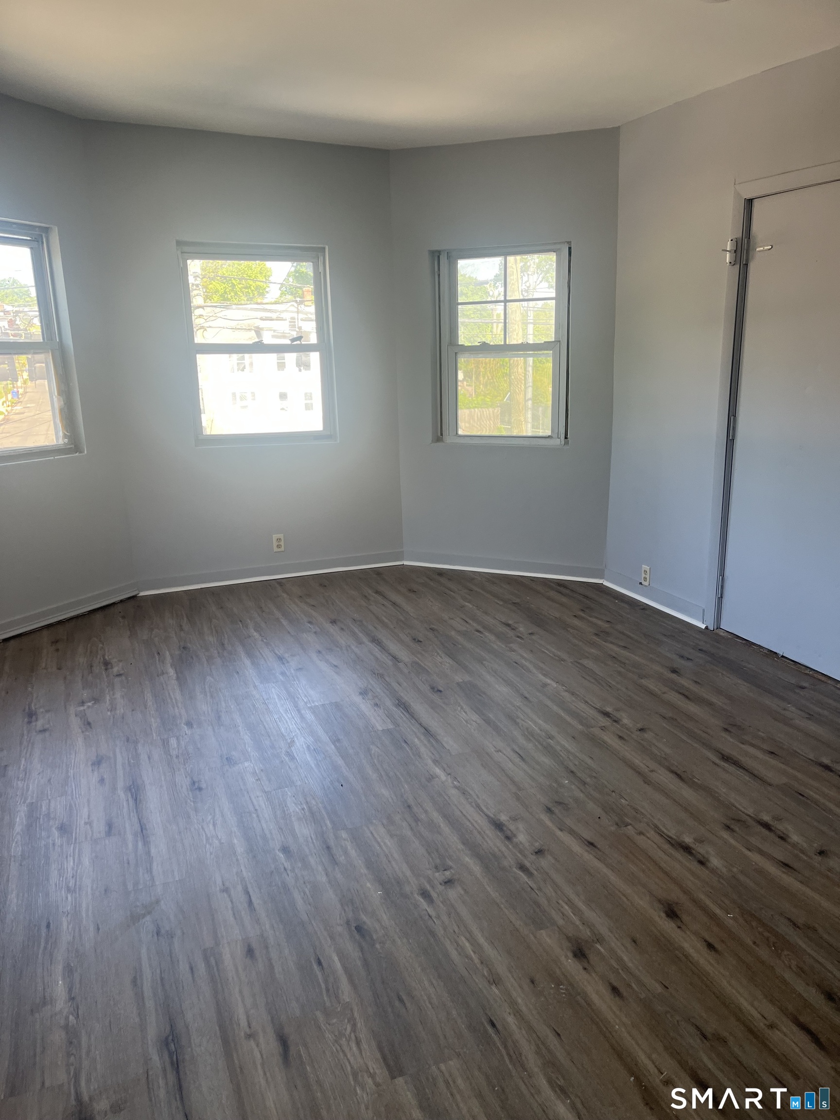 288 Cook Avenue Meriden, CT 06451 - Photo 6 of 11 a view of an empty room with wooden floor and a window