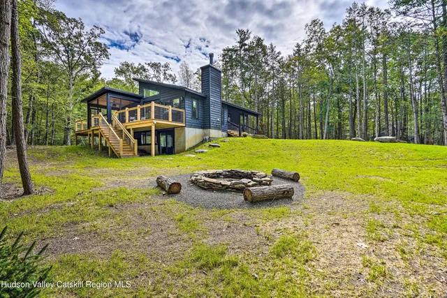 a view of a livingroom with wooden floor and furniture