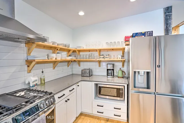 a kitchen with stainless steel appliances a refrigerator and a stove