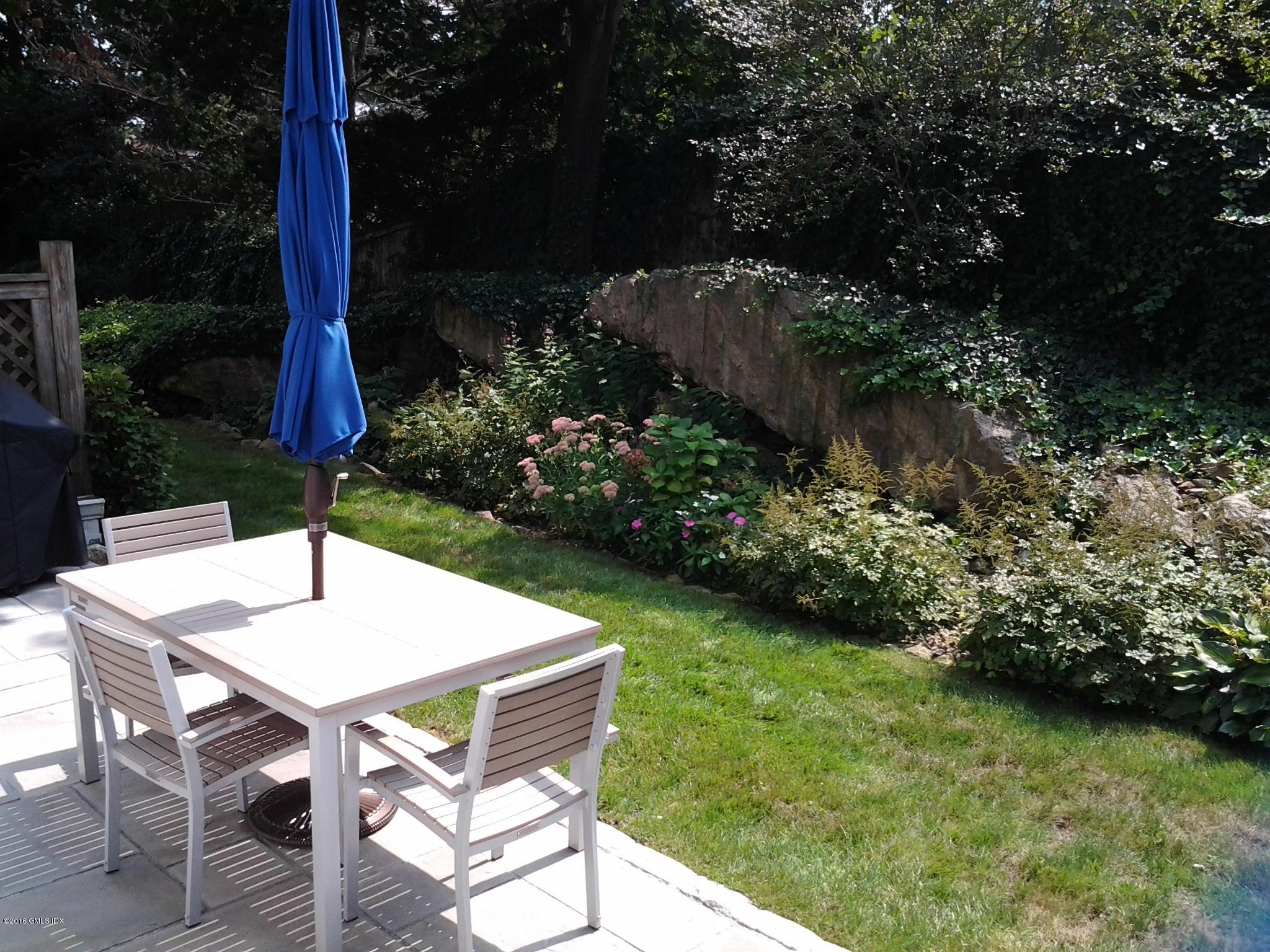 28 Home Place, Unit B2 Greenwich, CT 06830 - Photo 15 of 15 a table and chairs sitting in backyard of house