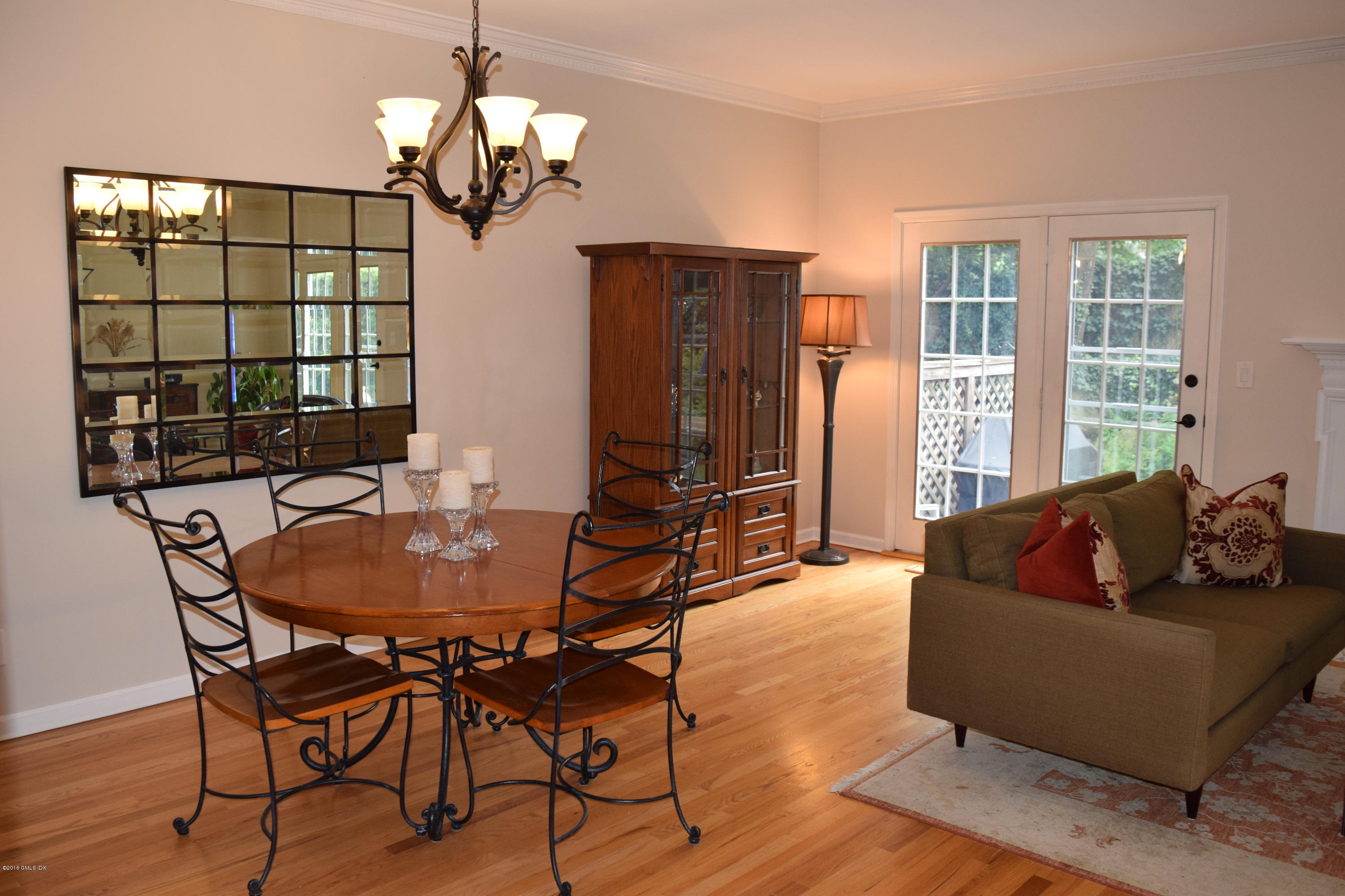 28 Home Place, Unit B2 Greenwich, CT 06830 - Photo 3 of 15 a living room with furniture a chandelier and a large window