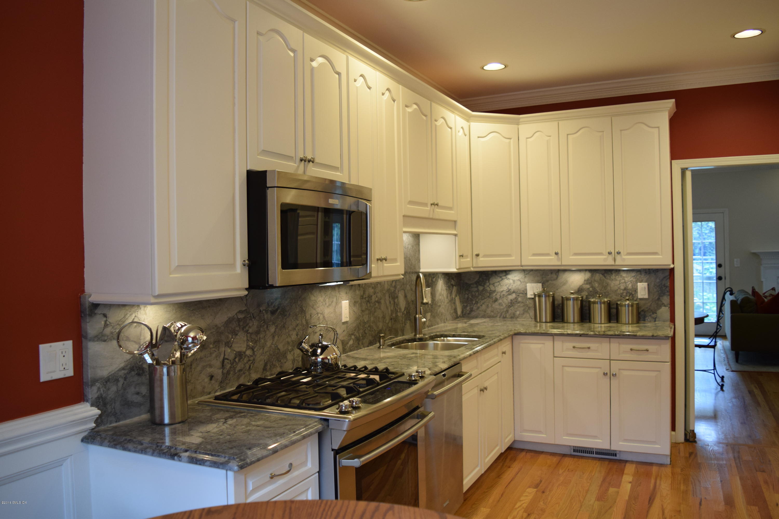 28 Home Place, Unit B2 Greenwich, CT 06830 - Photo 5 of 15 a kitchen with stainless steel appliances granite countertop a stove a sink and a microwave