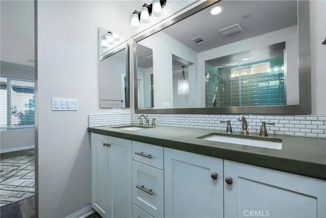 a bathroom with a double vanity sink and a mirror
