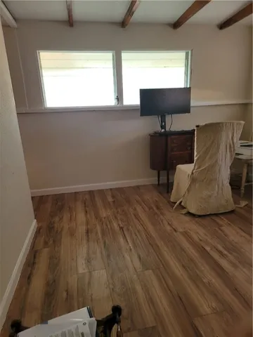 a view of workspace with wooden floor windows