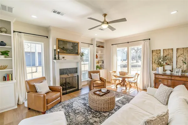 a living room with furniture a fireplace and a flat screen tv