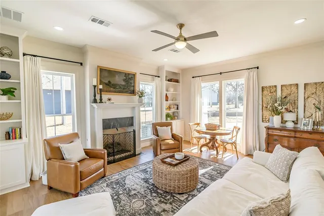 a living room with furniture a fireplace and a flat screen tv