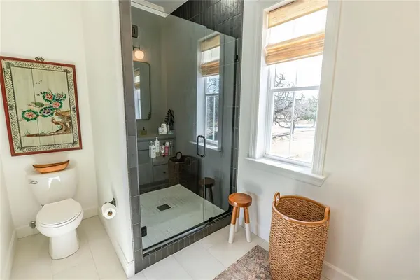 a bathroom with a toilet a sink and a window