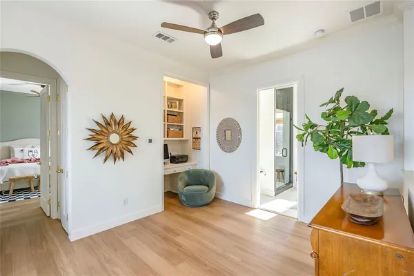 a living room with furniture and a potted plant