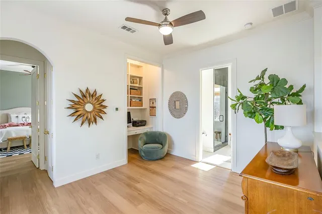 a living room with furniture and a potted plant
