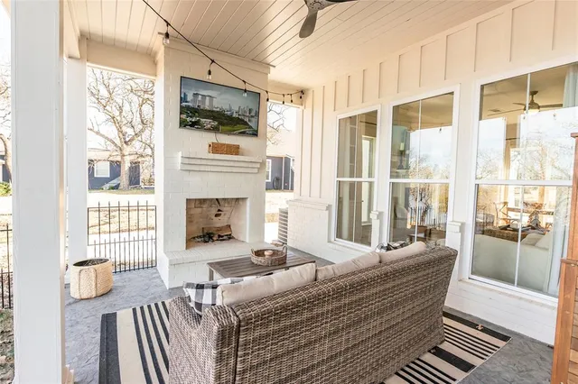 a living room with furniture and a floor to ceiling window