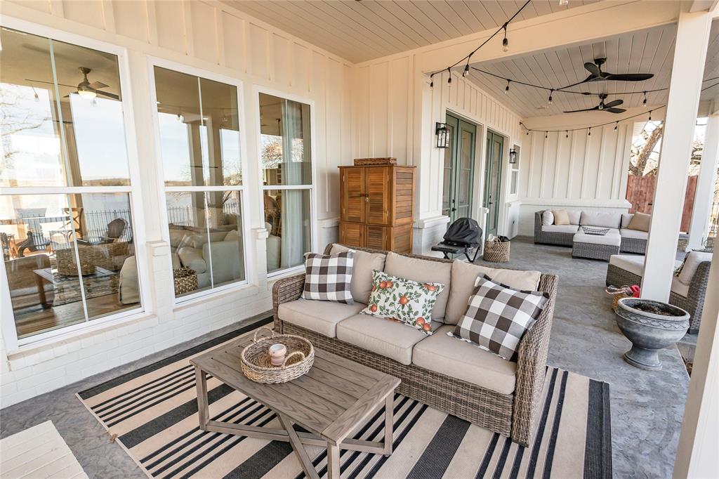 1061 Tradewinds Road Nocona, TX 76255 - Photo 34 of 40 a living room with furniture and a floor to ceiling window