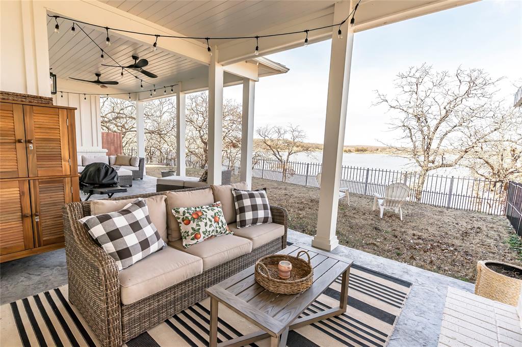 1061 Tradewinds Road Nocona, TX 76255 - Photo 35 of 40 a living room with furniture and a floor to ceiling window