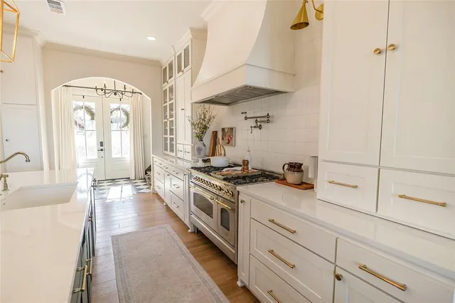 a kitchen with stainless steel appliances granite countertop a stove and a sink