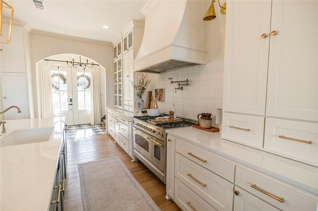1061 Tradewinds Road Nocona, TX 76255 - Photo 7 of 40 a kitchen with stainless steel appliances granite countertop a stove and a sink